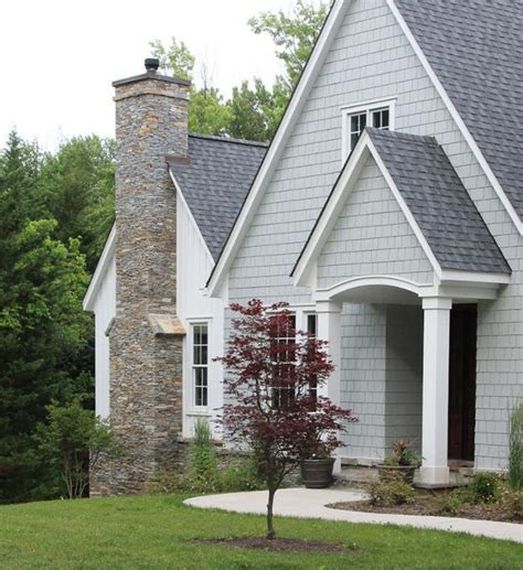 houses painted dark grey with metal roofs|grey house with black awnings.